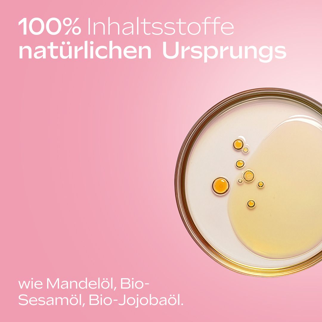 Nahaufnahme von Öl. Text: 100% Inhaltsstoffe natürlichen Ursprungs. Mandelöl, Bio-Sesamöl, Bio-Jojobaöl.