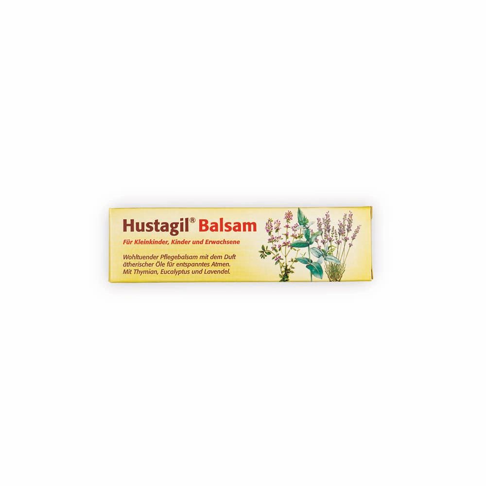 Emballage de Hustagil® Balsam. Boîte jaune avec nom du produit et illustrations florales.