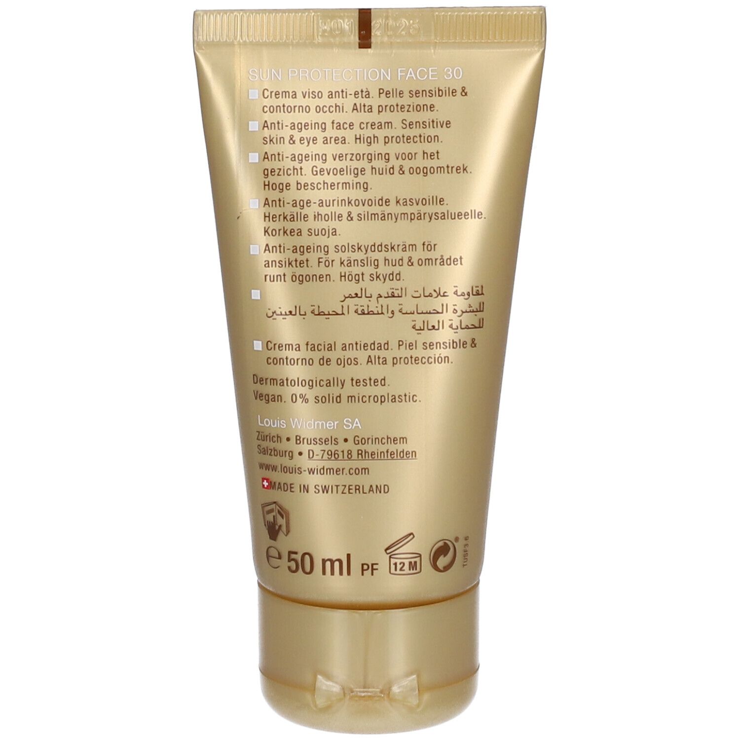 Dos du tube doré. Texte en plusieurs langues. Informations sur le produit, ingrédients, adresse du fabricant et logo.