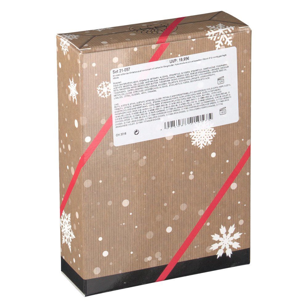 Dos de l'emballage du coffret cadeau. Texte sur une étiquette blanche. Emballage avec motif flocons et ruban rouge.