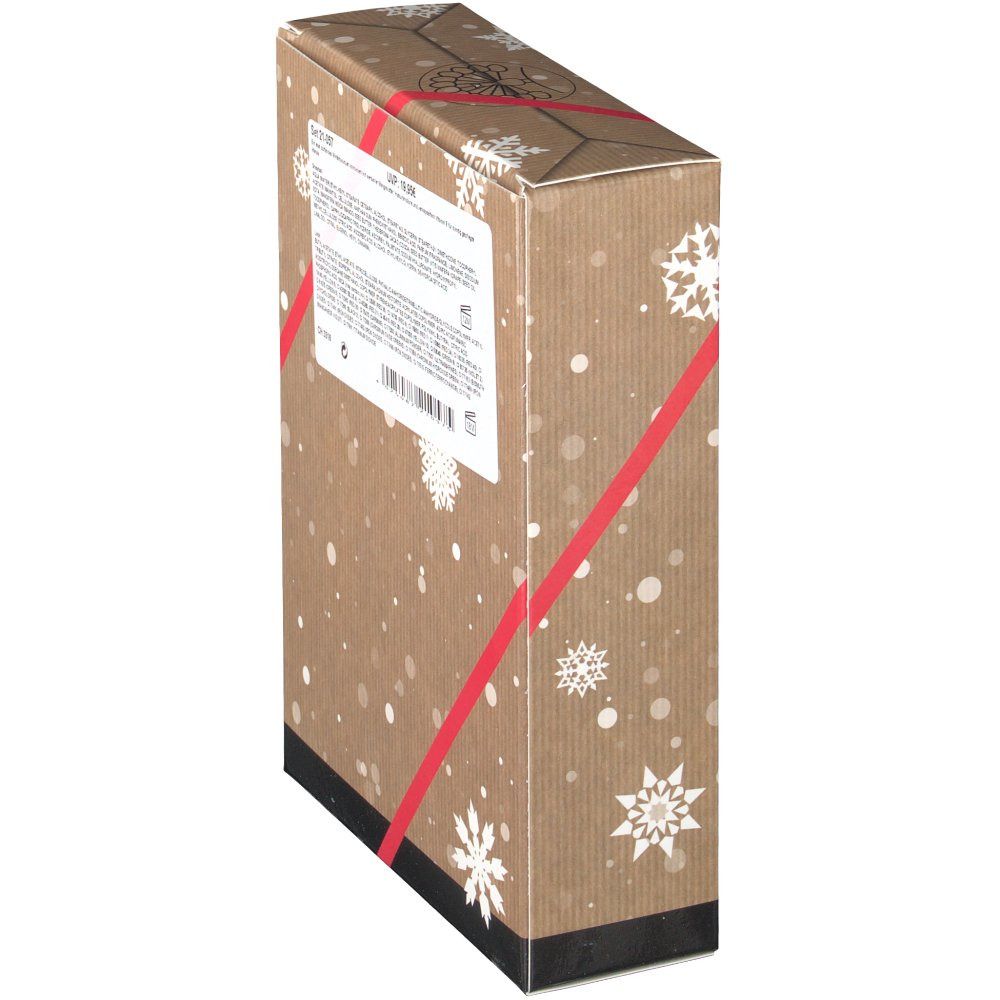 Vue latérale de l'emballage du coffret cadeau. Texte sur une étiquette blanche. Emballage avec motif flocons et ruban rouge.