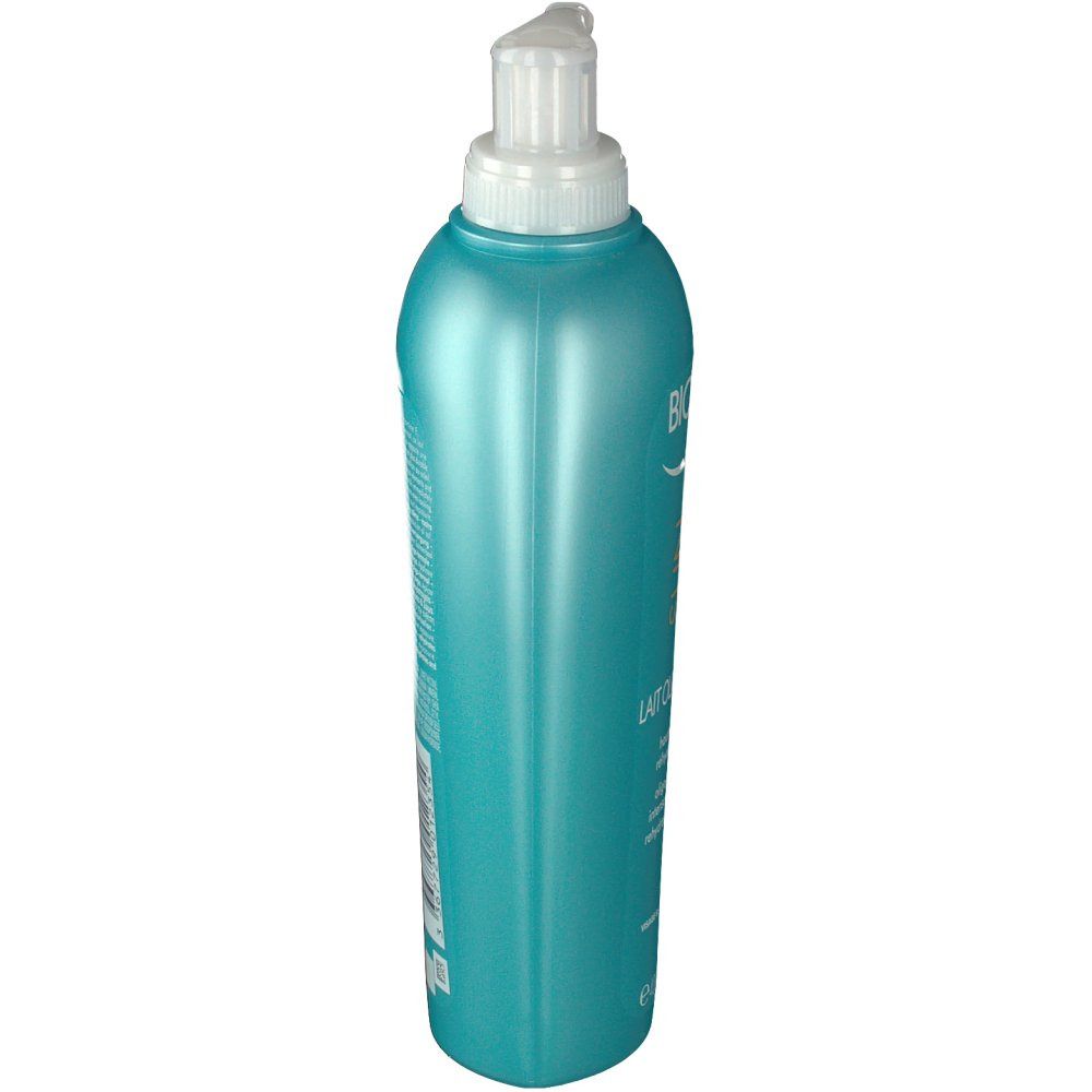 Türkisgrüne Flasche mit Pumpe. Blick von oben. Aufschrift nicht lesbar.