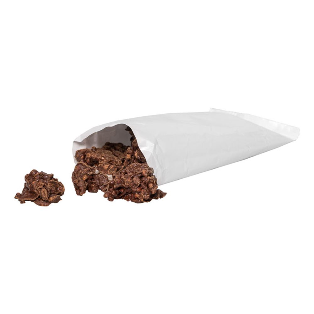 Sachet blanc ouvert avec des Protein Crossies. Quelques Crossies sont à côté.