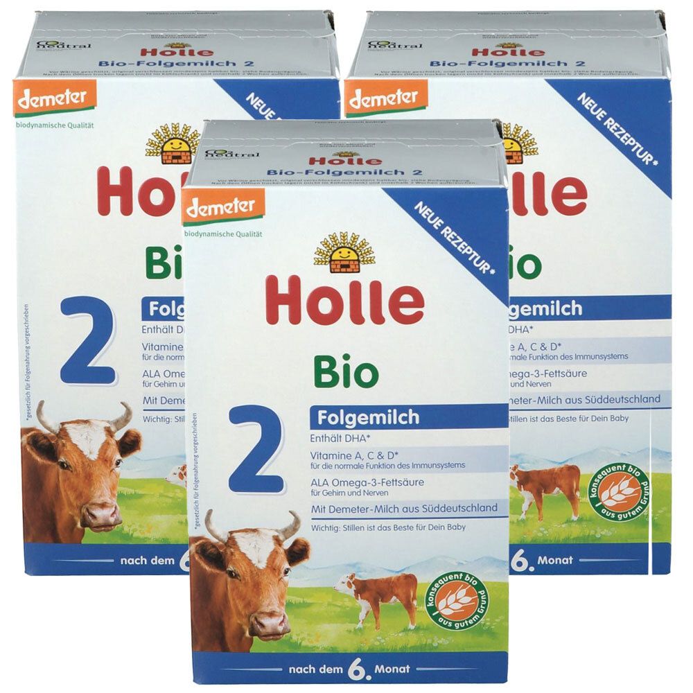 Mehrere Packungen Holle Bio-Folgemilch 2. Aufdrucke: Demeter, Bio, 2, Kuh, 6. Monat, Neue Rezeptur. Kartonverpackung.