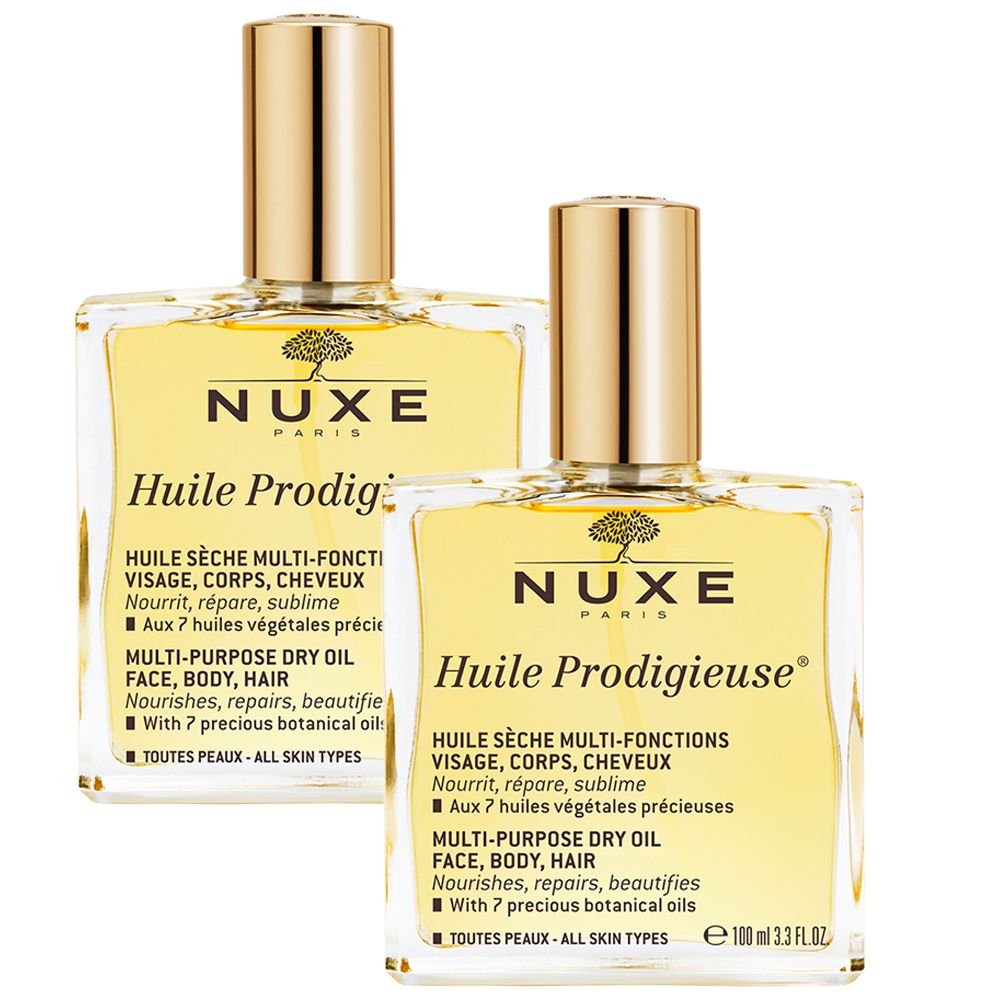 Deux flacons d'huile NUXE Huile Prodigieuse®. Flacons dorés avec bouchons dorés. Texte sur l'étiquette.