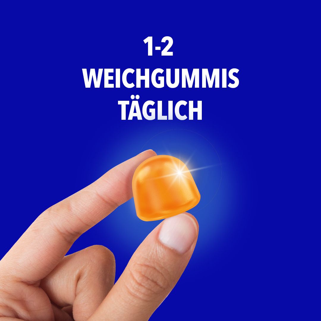 Hand hält ein orangefarbenes Weichgummi. Text: 1-2 Weichgummis täglich.