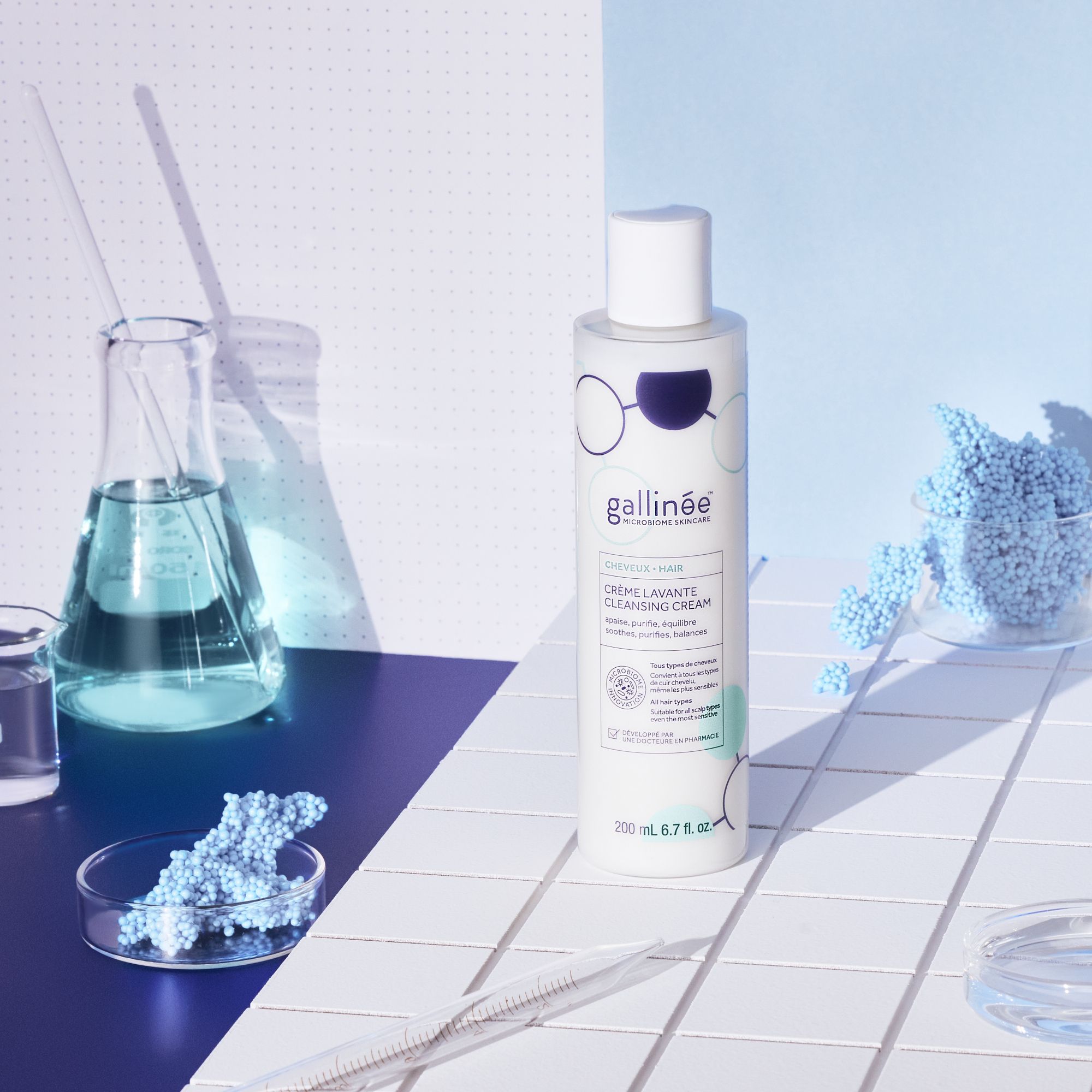 Flacon de shampooing et matériel de laboratoire. Flacon avec graphiques bleus et blancs. Marque : Gallinée.