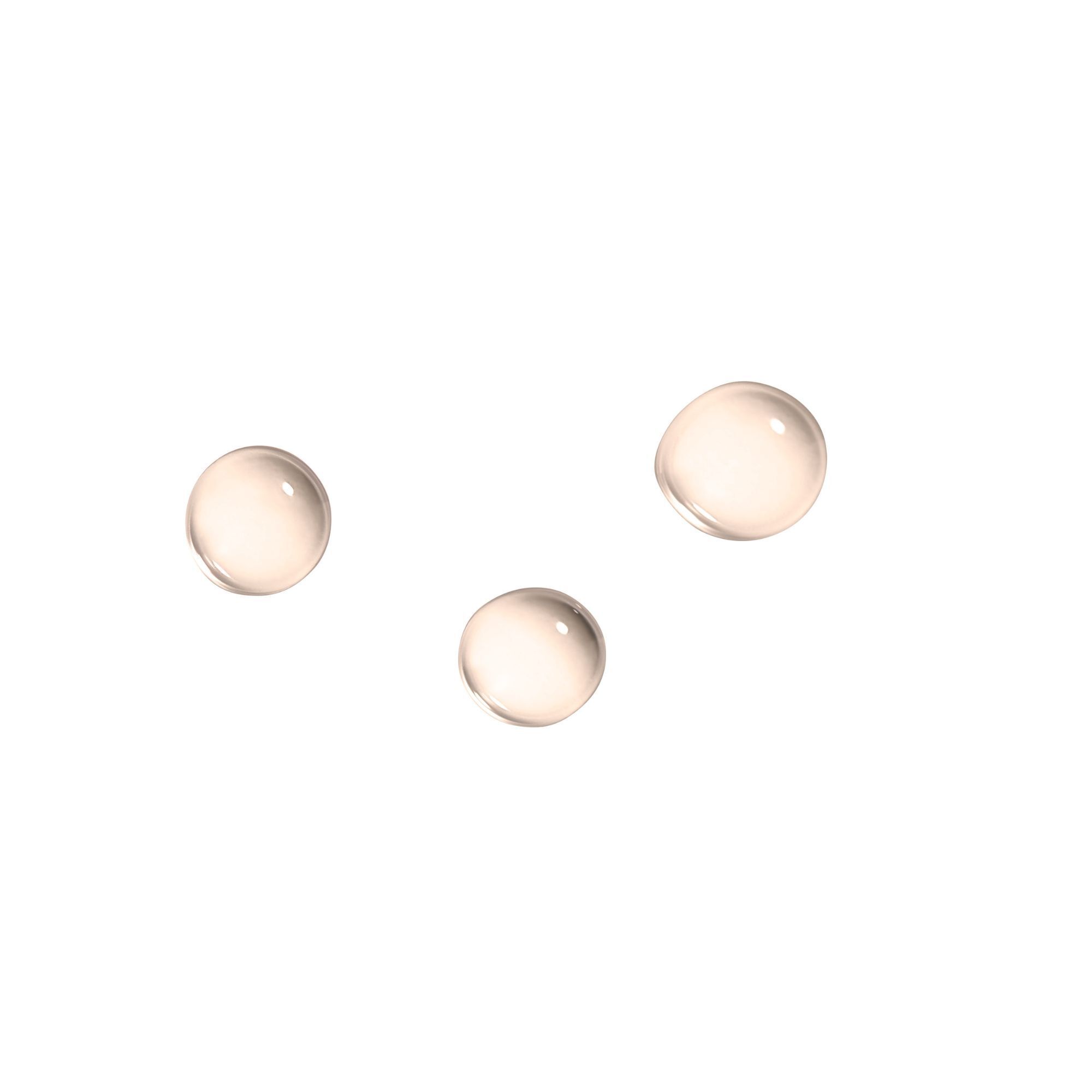 Trois gouttes rondes et transparentes sur fond blanc.