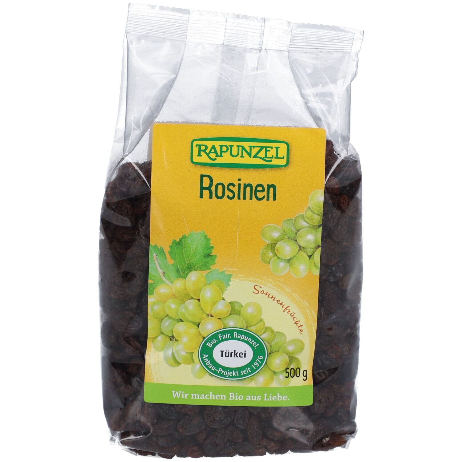 RAPUNZEL Rosinen in transparenter Verpackung. Gelbes Etikett mit Logo, Schriftzug und Trauben-Illustration. 500g.