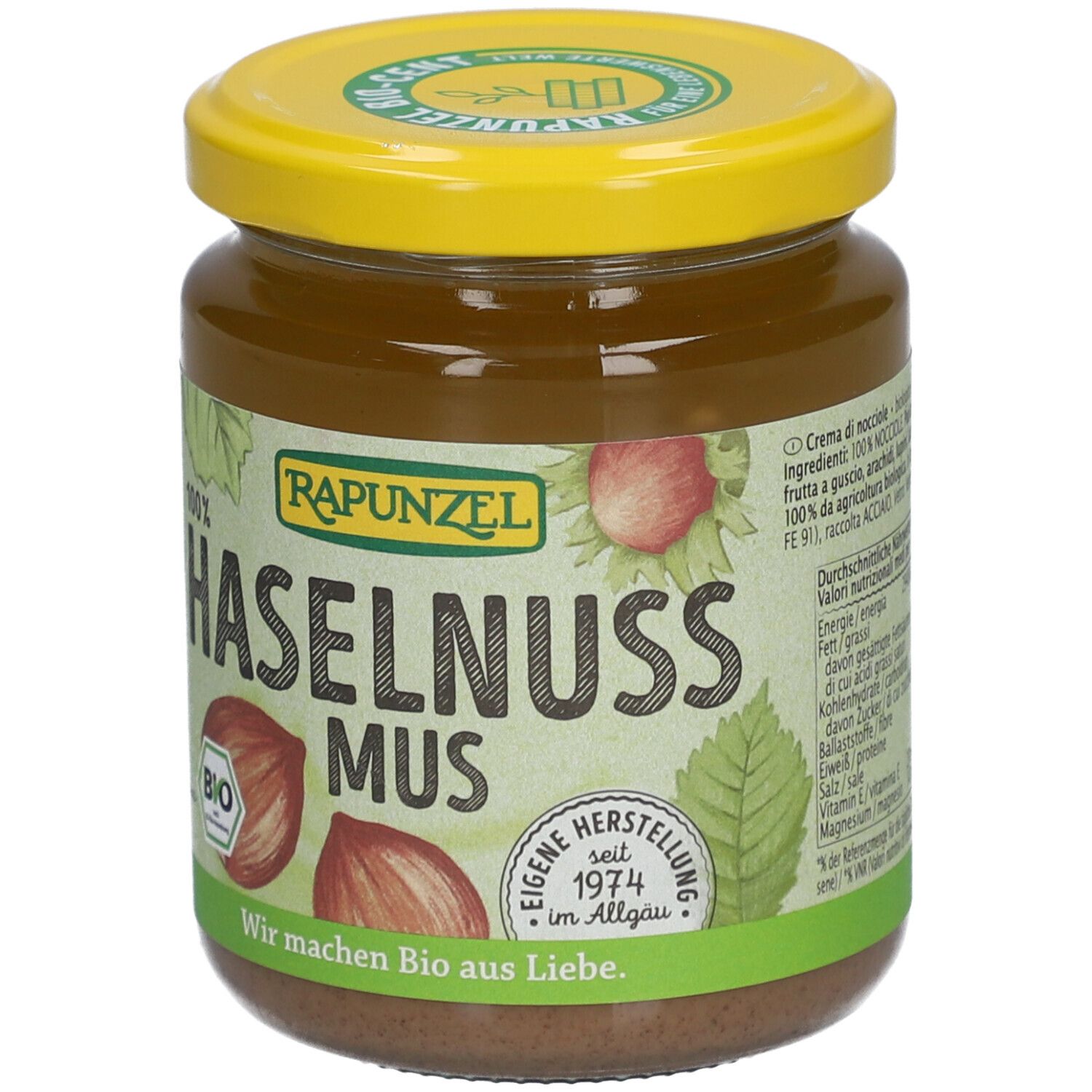 Glas mit Haselnussmus. Gelber Deckel, Etikett mit Text und Nährwertangaben. Aufschrift: RAPUNZEL, BIO, 250g.