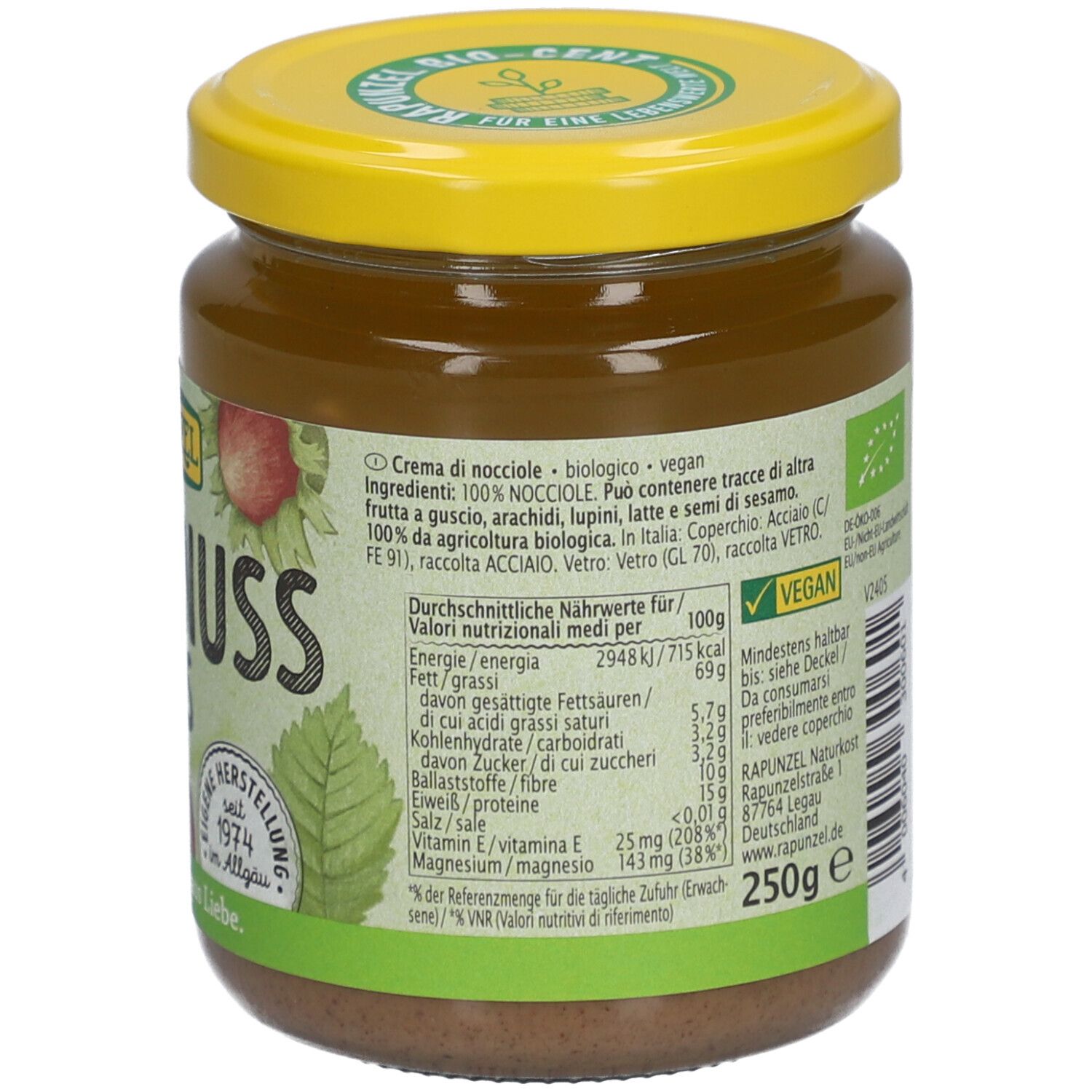 Glas mit Haselnussmus. Gelber Deckel, Etikett mit Nährwertangaben. Aufschrift: Vegan, 250g, BIO-Siegel.
