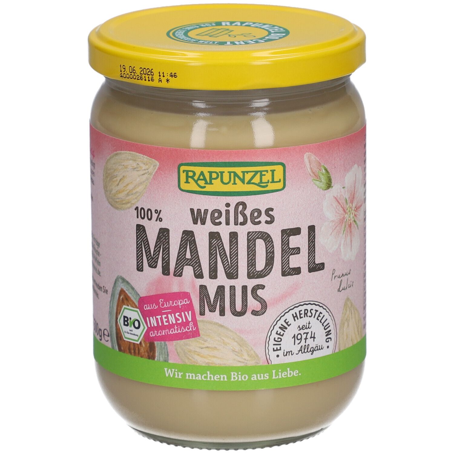Glas mit weißem Mandelmus. Aufschrift: RAPUNZEL, weißes Mandelmus, Bio. Mit gelbem Deckel.