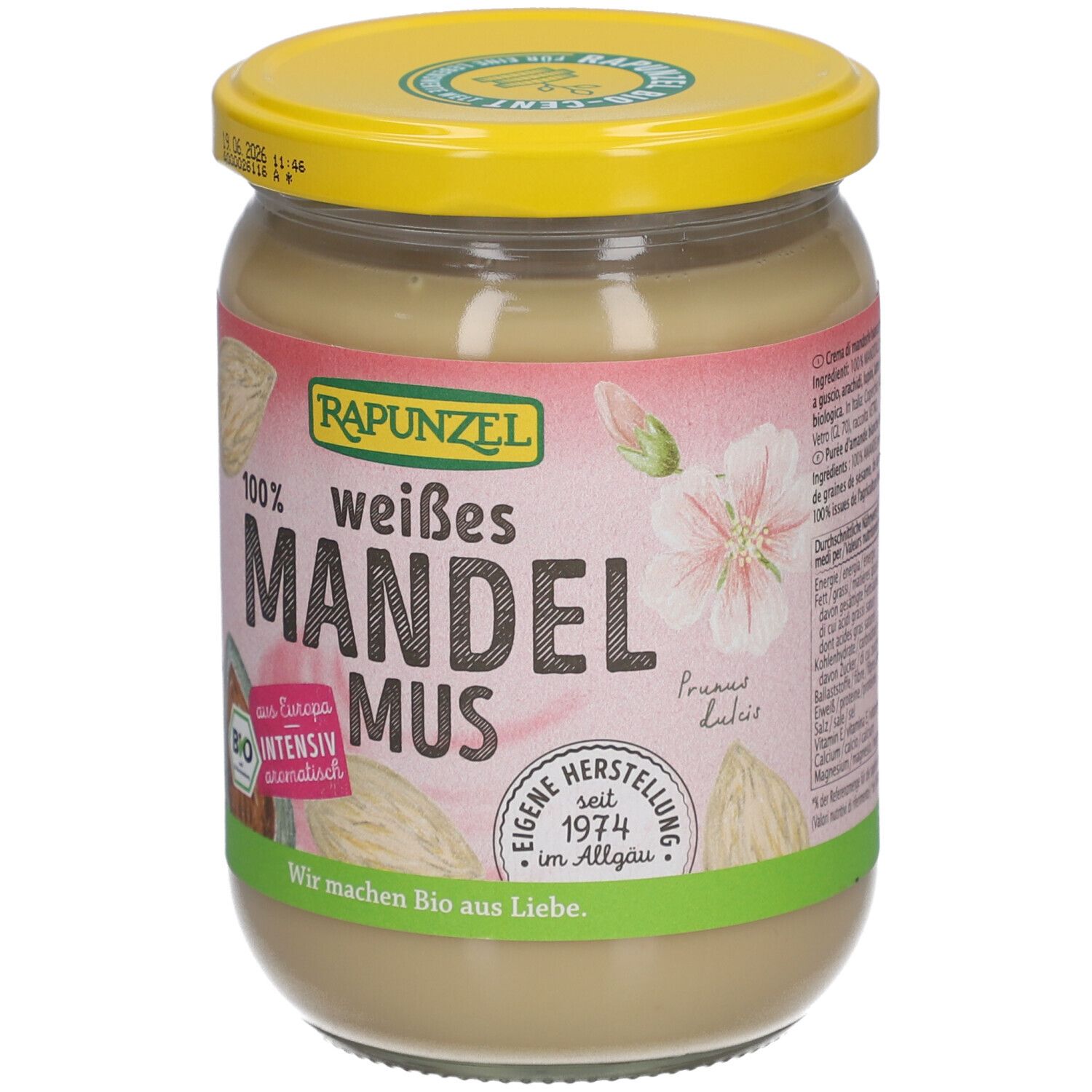 Glas mit weißem Mandelmus. Aufschrift: RAPUNZEL, weißes Mandelmus, Bio. Mit gelbem Deckel.