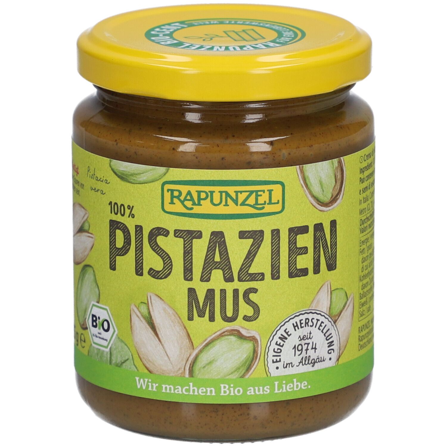 Glas mit Rapunzel Pistazienmus. Gelber Deckel, grünes Etikett mit Pistazien-Illustrationen und Schriftzug.