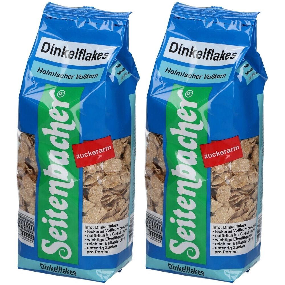 Deux paquets de Dinkelflakes. Emballage bleu avec nom du produit et marque Seitenbacher. Étiquette rouge "zuckerarm".