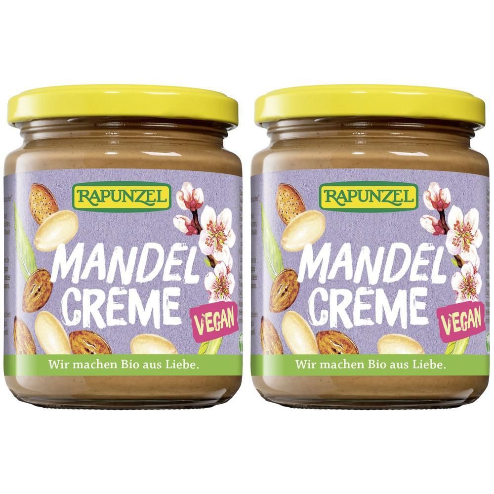Deux pots de crème de amandes avec couvercles jaunes. Inscription: RAPUNZEL MANDEL CREME, vegan. Illustrations d'amandes et de fleurs.