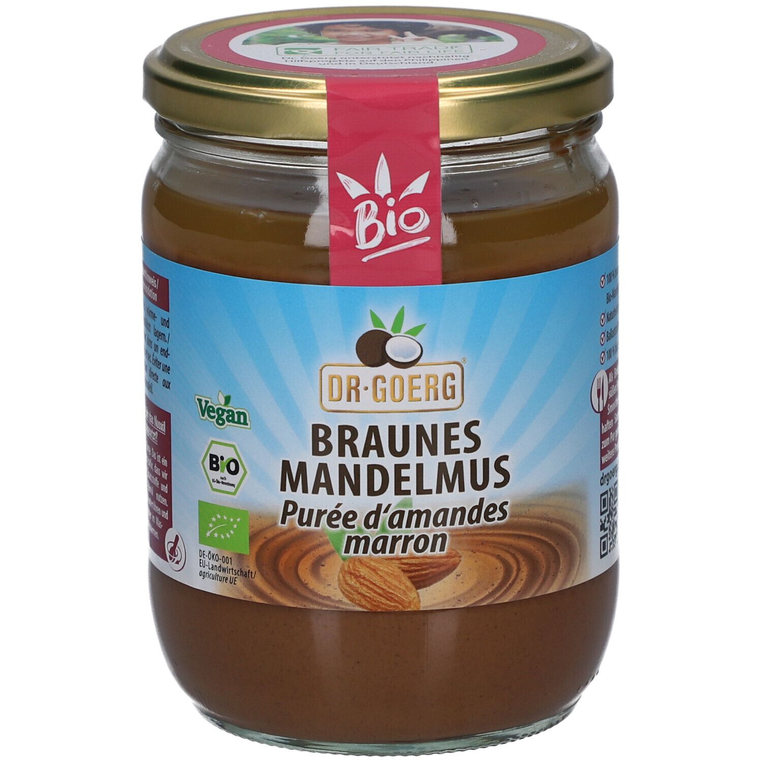 Glas mit braunem Mandelmus. Aufschrift: Dr. Goerg, Braunes Mandelmus, Bio, Vegan. Mandel-Abbildung.