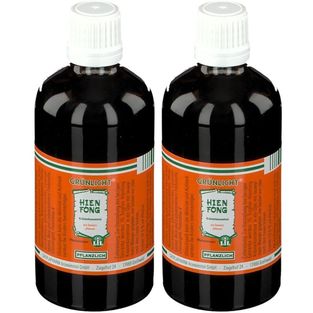 Deux flacons de Grünlicht Hienfong Kräuterkonzentrat Tropfen. Liquide brun dans des bouteilles en verre avec des bouchons blancs et des étiquettes orange.