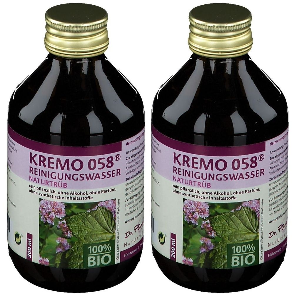 Deux flacons de liquide brun foncé. Étiquette avec texte: KREMO 058® REINIGUNGSWASSER NATURTRÜB. Label 100% BIO.