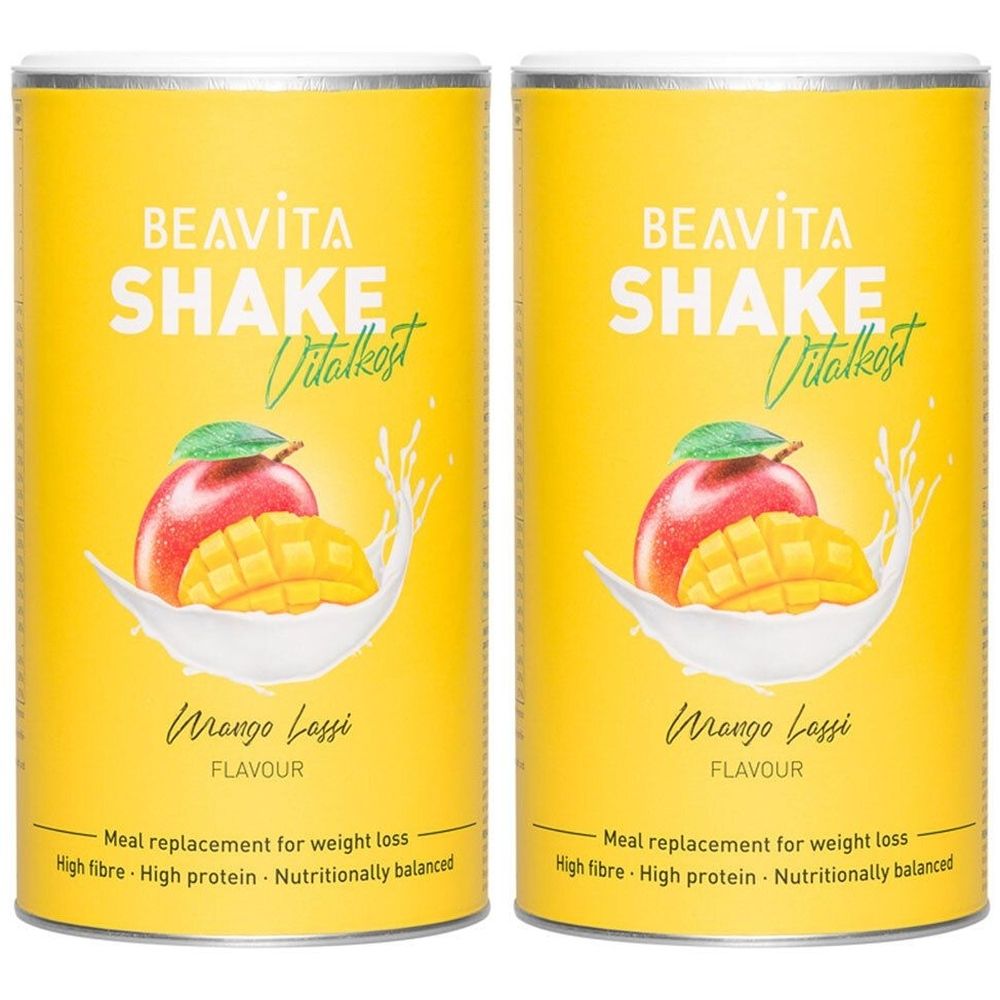 Zwei gelbe Dosen mit Aufschrift BEAVITA SHAKE Vitalkost. Mango Lassi-Geschmack. Abbildung von Mango und Milch.
