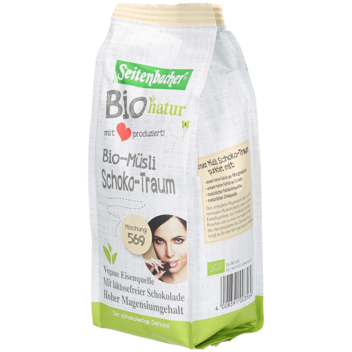 Verpackung von Seitenbacher Bio-Müsli Schoko-Traum. Aufdrucke: Bio-natur, vegane Eisenquelle, laktosefreie Schokolade, hoher Magnesiumgehalt. Frau mit Schokoriegel.