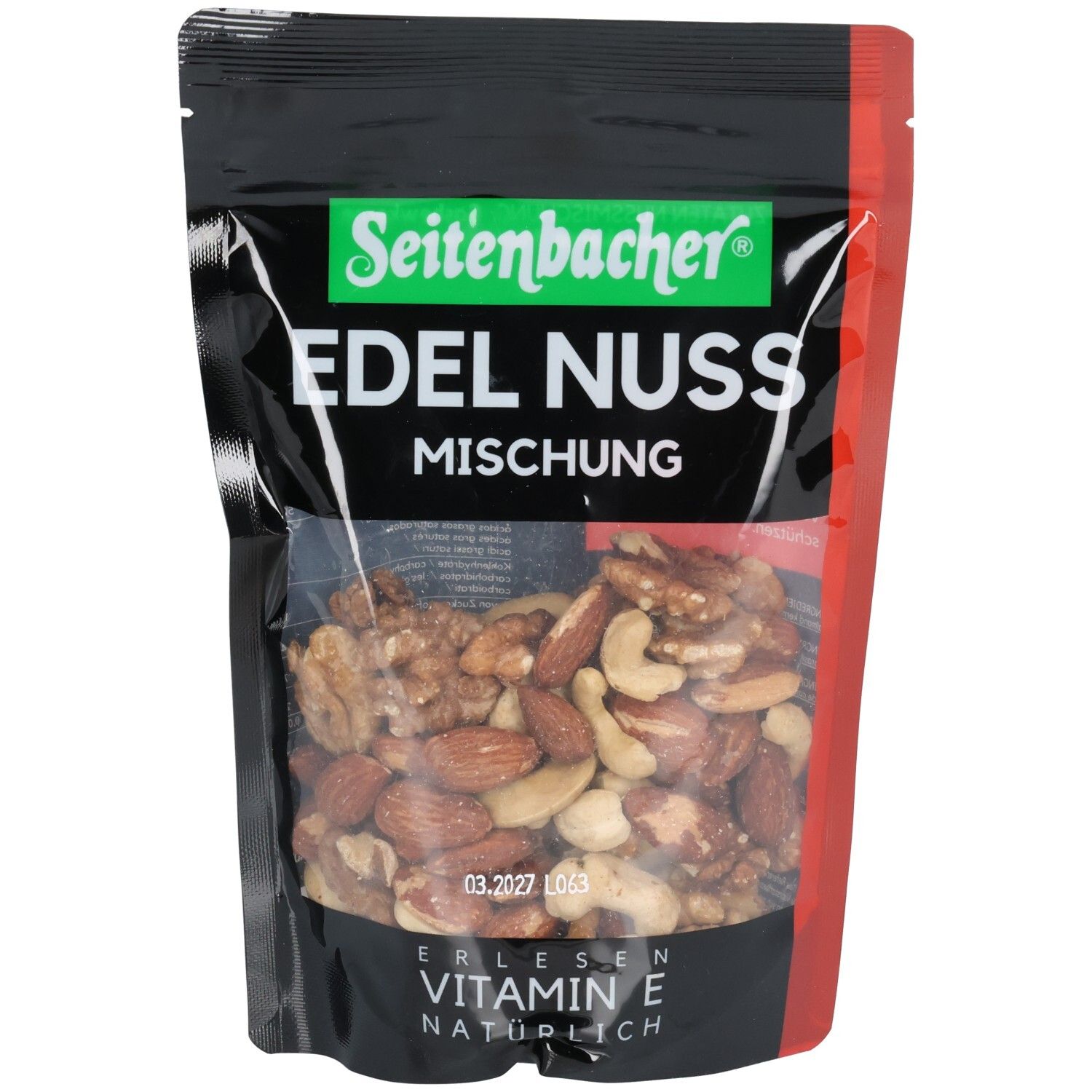 Sachet noir avec mélange de noix Seitenbacher. Fenêtre transparente montrant des noix. Inscription verte, "EDEL NUSS MISCHUNG".
