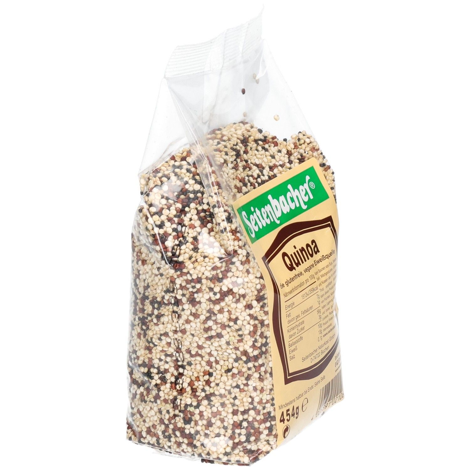 Sachet de quinoa en biais. Inscription: Seitenbacher, Quinoa, informations nutritionnelles, 454g. Grains multicolores.