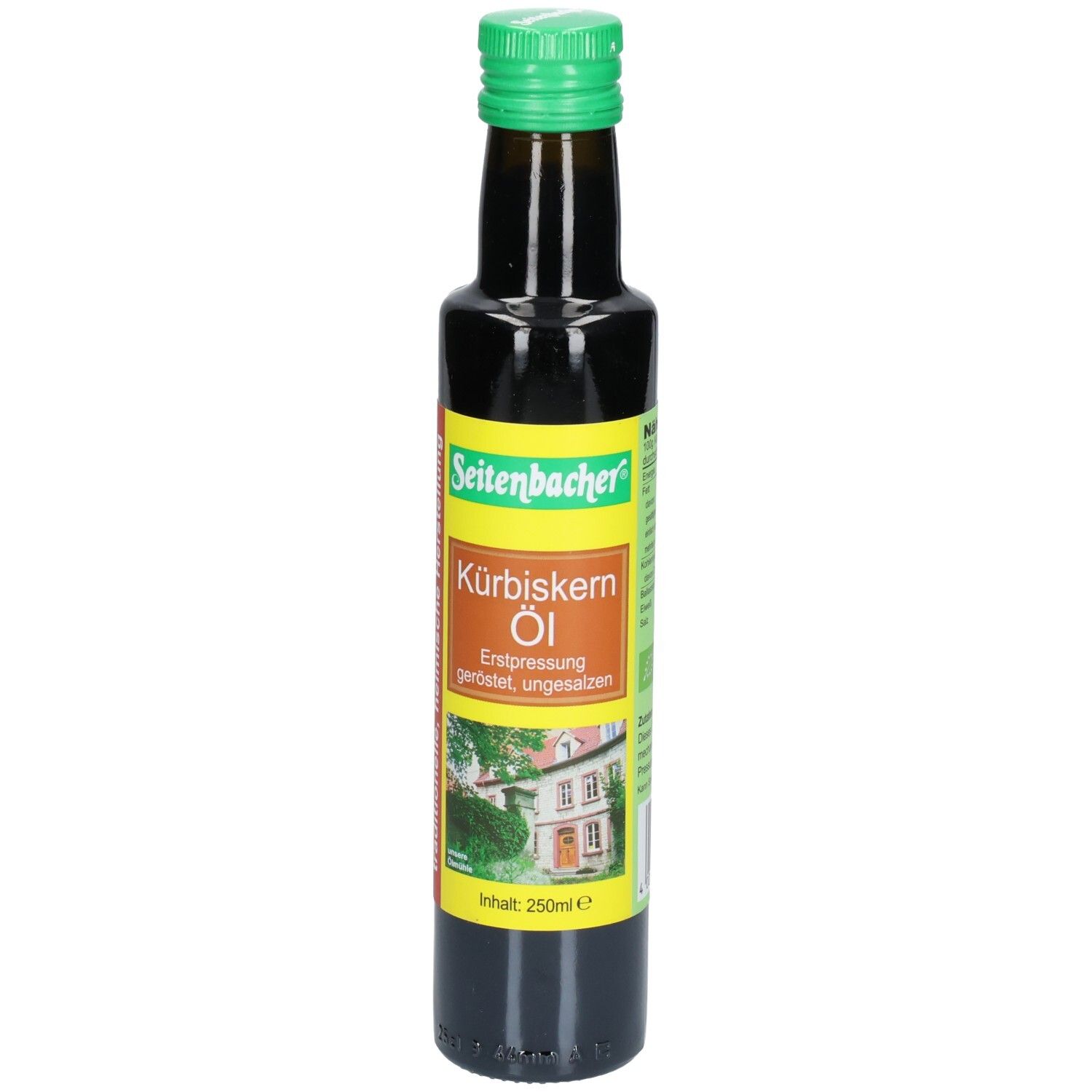Bouteille en verre brun avec bouchon vert. Étiquette avec nom du produit et image d'une maison. Seitenbacher Kürbiskern Öl.
