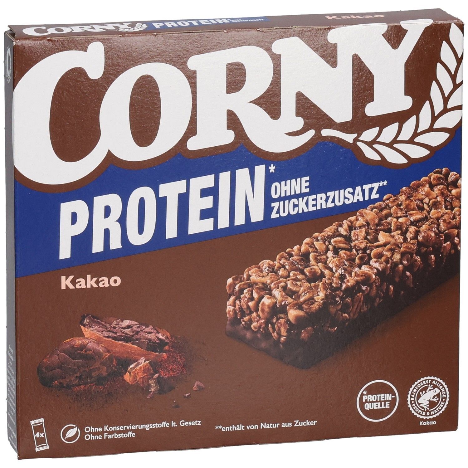 Braune Schachtel mit Corny Protein Kakao. Aufdruck: Corny, Protein, ohne Zuckerzusatz. Abbildung von Riegel und Kakaobohnen.
