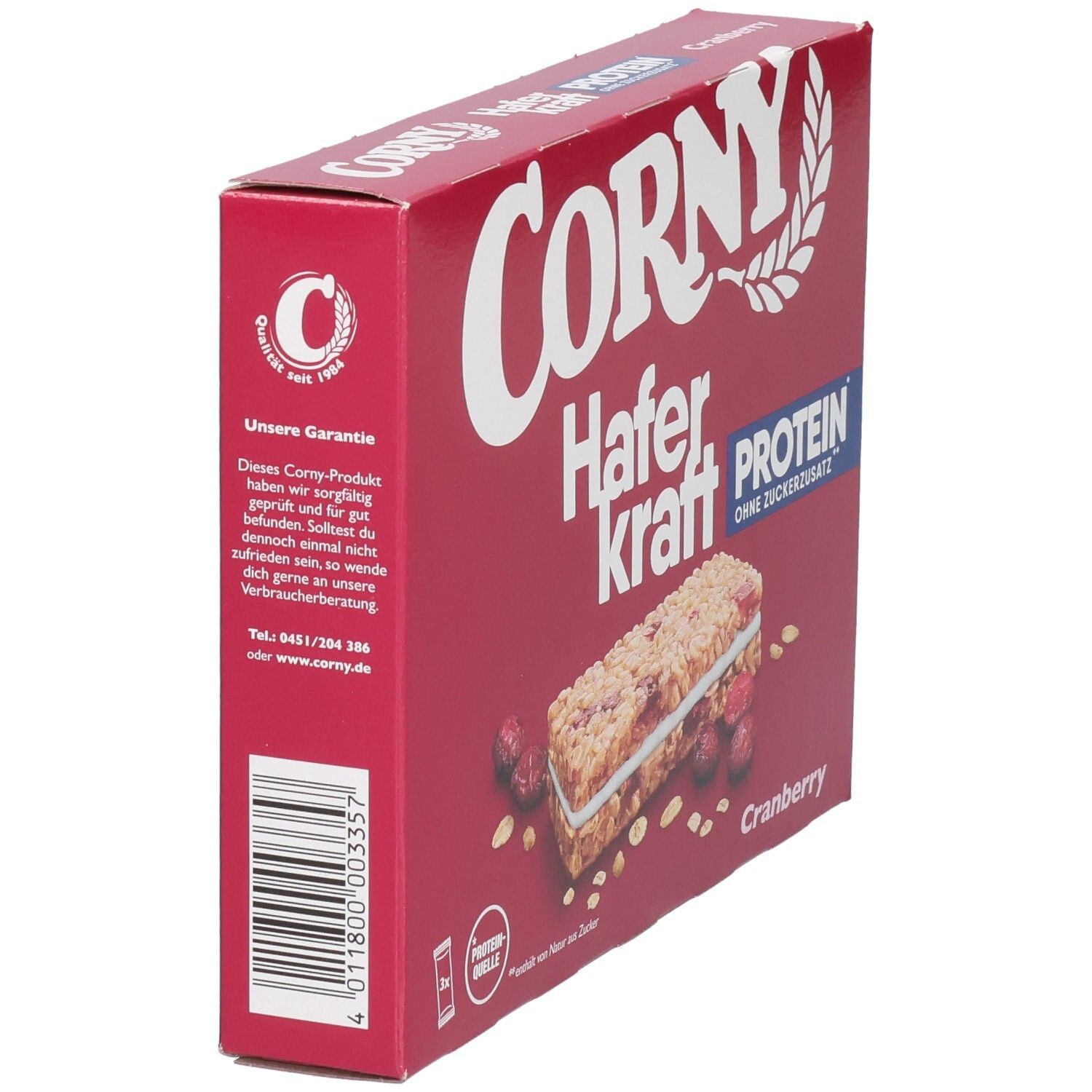 Boîte rouge Corny Haferkraft Protein Cranberry, vue latérale. Texte : Protéines, sans sucre ajouté. Logo : Corny. Canneberges et barre.