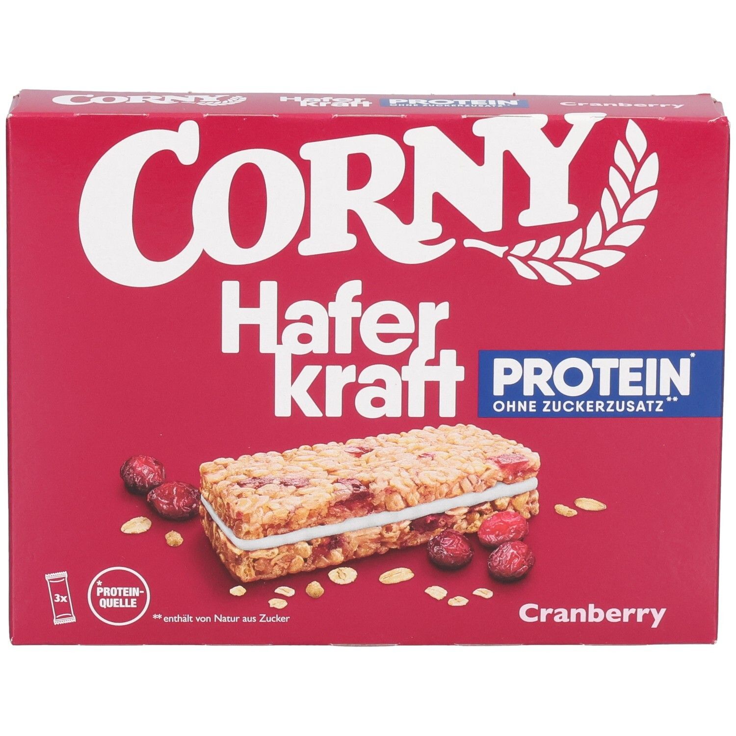 Boîte rouge Corny Haferkraft Protein Cranberry. Illustré : barre, canneberges et flocons d'avoine. Texte : Protéines, sans sucre ajouté.