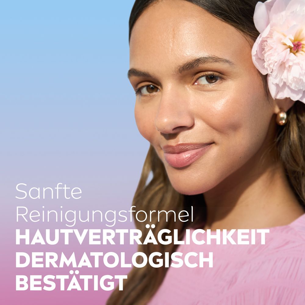 Frau mit Blume im Haar, sanfte Reinigungsformel, Hautverträglichkeit dermatologisch bestätigt.