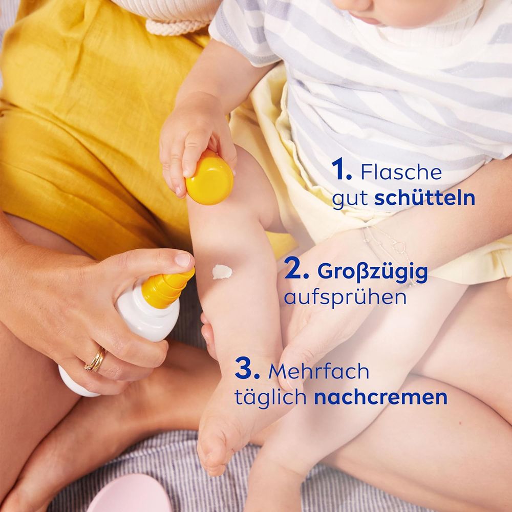 Application de Nivea Sun Bébés & Enfants Protection Sensible SPF 50+ sur la jambe d'un enfant.
