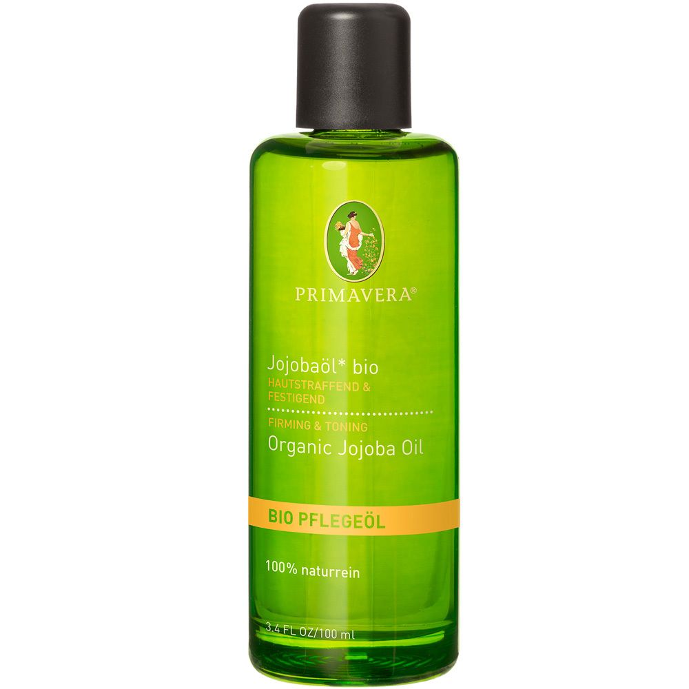 Flacon vert avec bouchon noir. Inscription: PRIMAVERA, Jojobaöl bio, Organic Jojoba Oil. Bande orange avec texte.