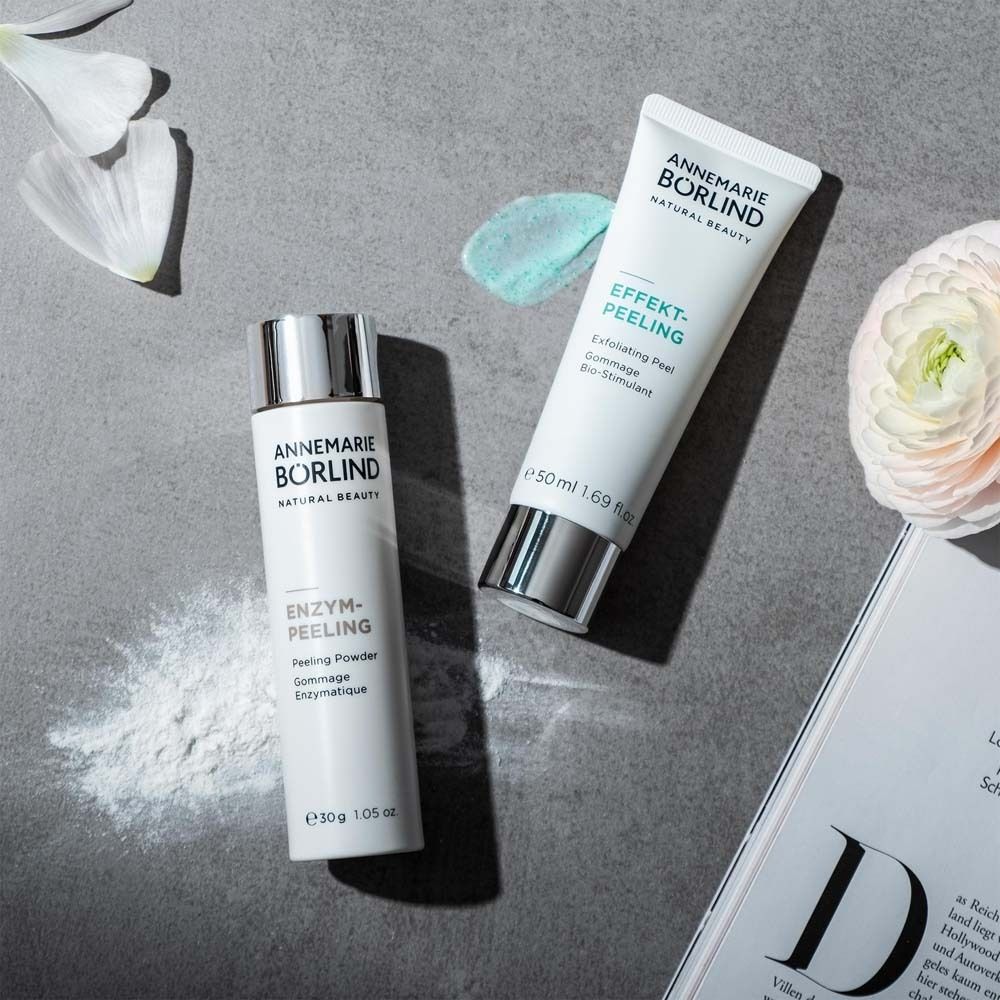 Deux produits et un magazine. Flacon blanc, tube. Inscription: ANNEMARIE BÖRLIND, ENZYM-PEELING, EFFEKT-PEELING.