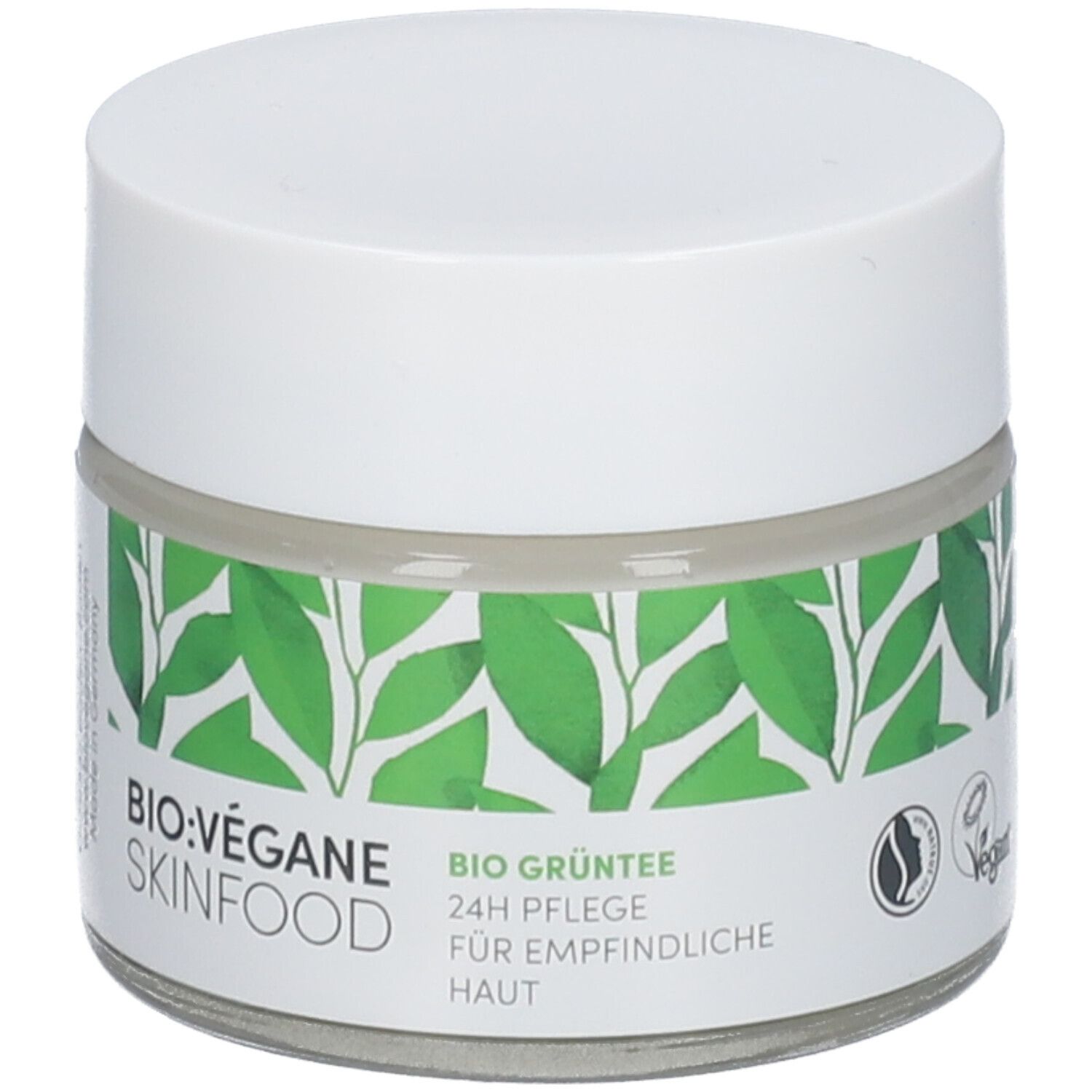Pot de crème avec couvercle blanc. Étiquette: BIO:VÉGANE SKINFOOD, BIO GRÜNTEE 24h Pflege für empfindliche Haut. Label Vegan.