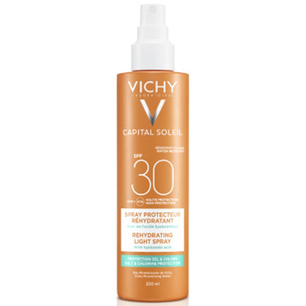 Spray solaire orange avec tête blanche. Inscriptions: VICHY, CAPITAL SOLEIL, SPF 30. Texte: Spray Protecteur Réhydratant. 
