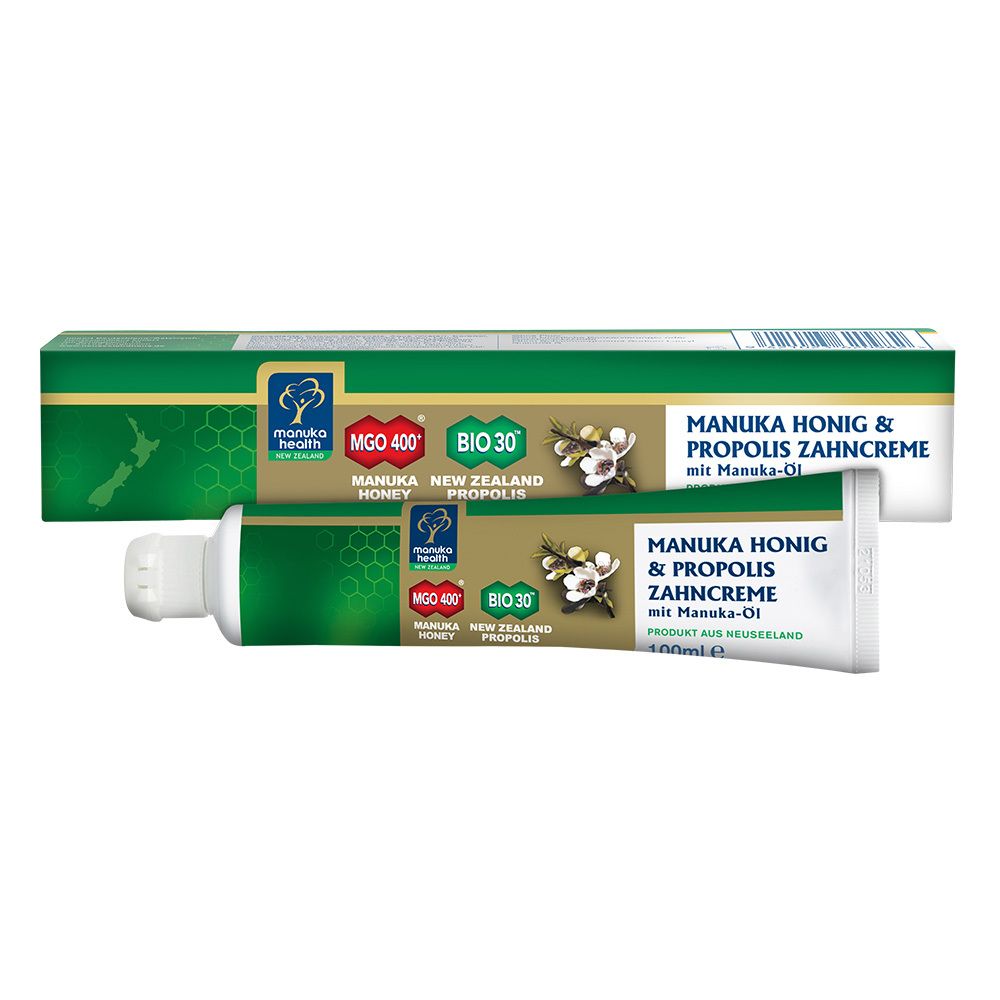 Tube et emballage de dentifrice. Vert, blanc et or. Texte : MANUKA HONIG & PROPOLIS ZAHNCREME.