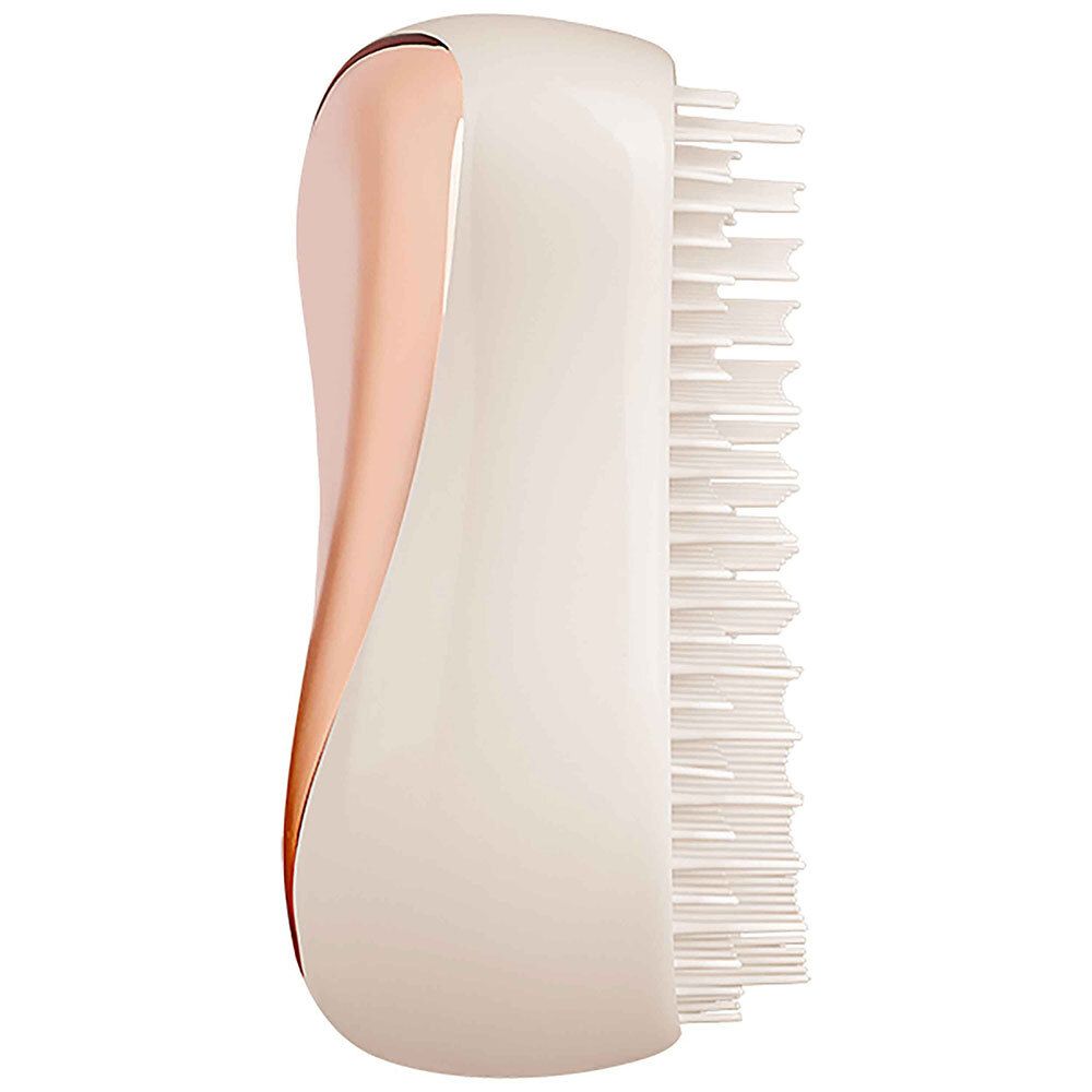 Brosse à cheveux avec surface or rose et corps blanc. Soies d'un côté.
