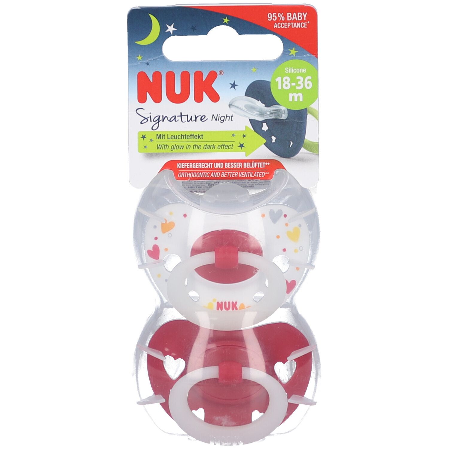 Deux sucettes en emballage. Tétines en silicone rouge et blanc. Emballage avec nom du produit, âge et effet lumineux.