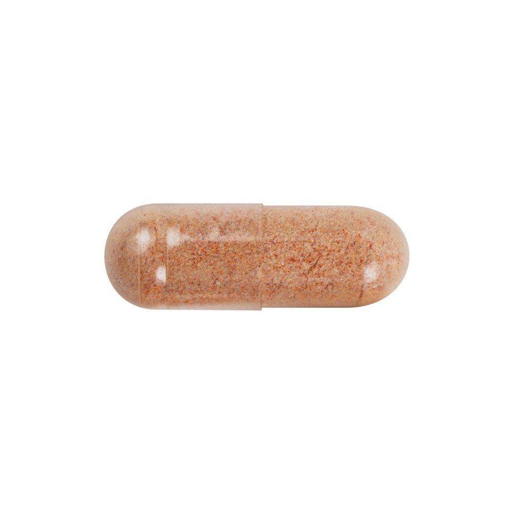 Einzelne Kapsel mit orangefarbenem Pulver.