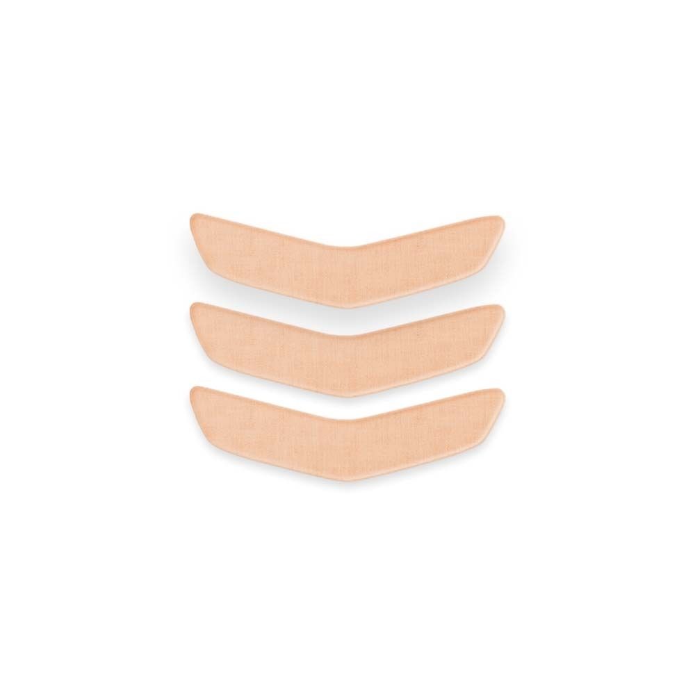 Trois patchs buccaux beiges, en forme de V. Sur fond clair.