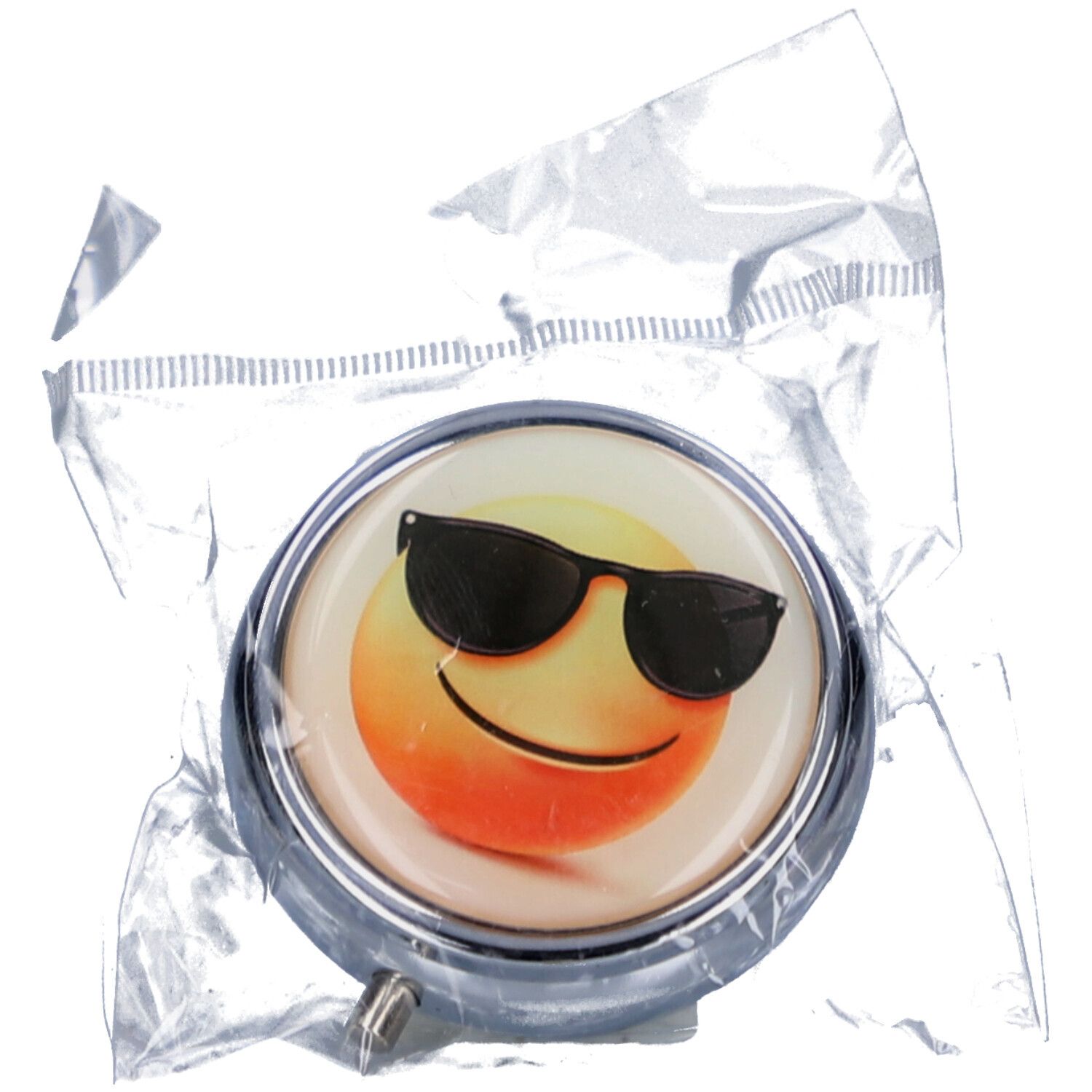Runde Pillendose mit Smiley-Motiv und Sonnenbrille, in Folienverpackung. Metallrahmen, silberfarben. Gelb, orange und schwarz.