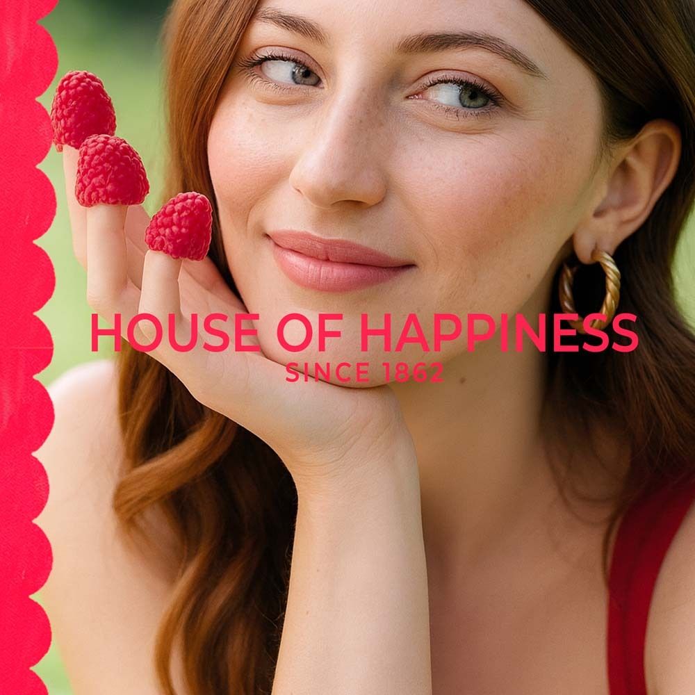 Femme avec framboises. Texte: HOUSE OF HAPPINESS, SINCE 1862.
