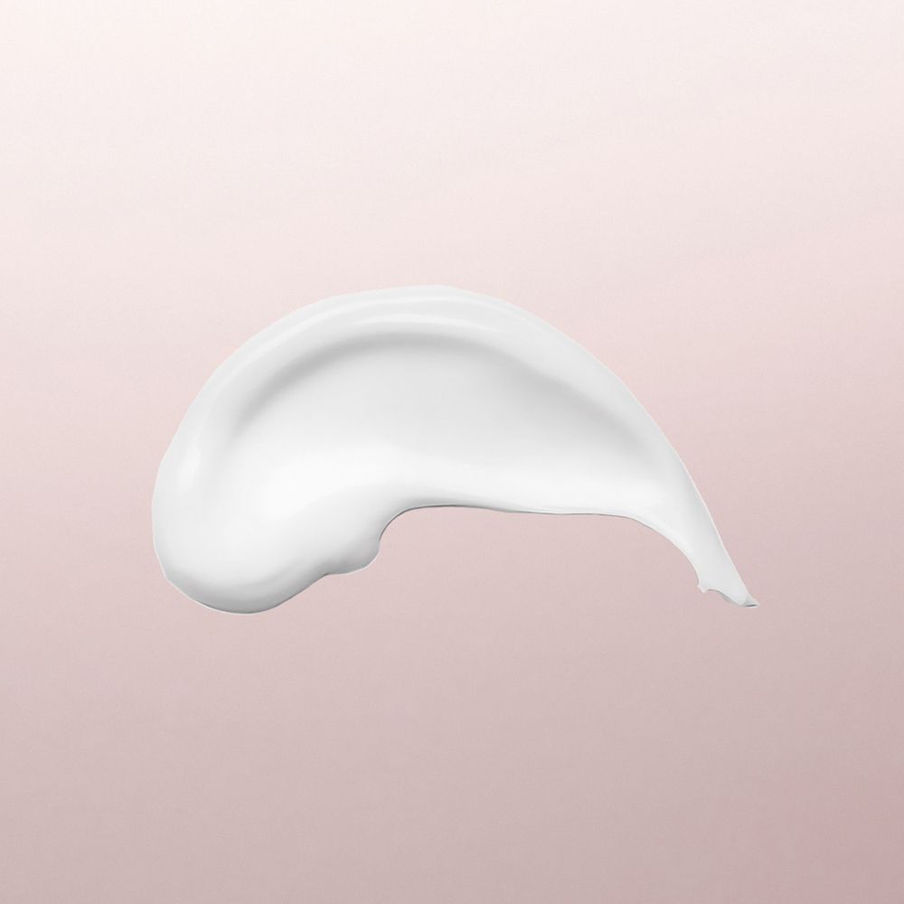 Une traînée d'émulsion de jour hydraderm Louis Widmer sur fond rose.