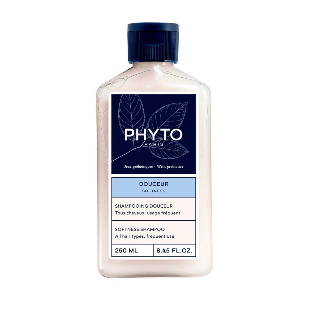 Flacon de shampooing PHYTO PARIS. Shampooing blanc avec bouchon bleu. Étiquette avec nom et informations.