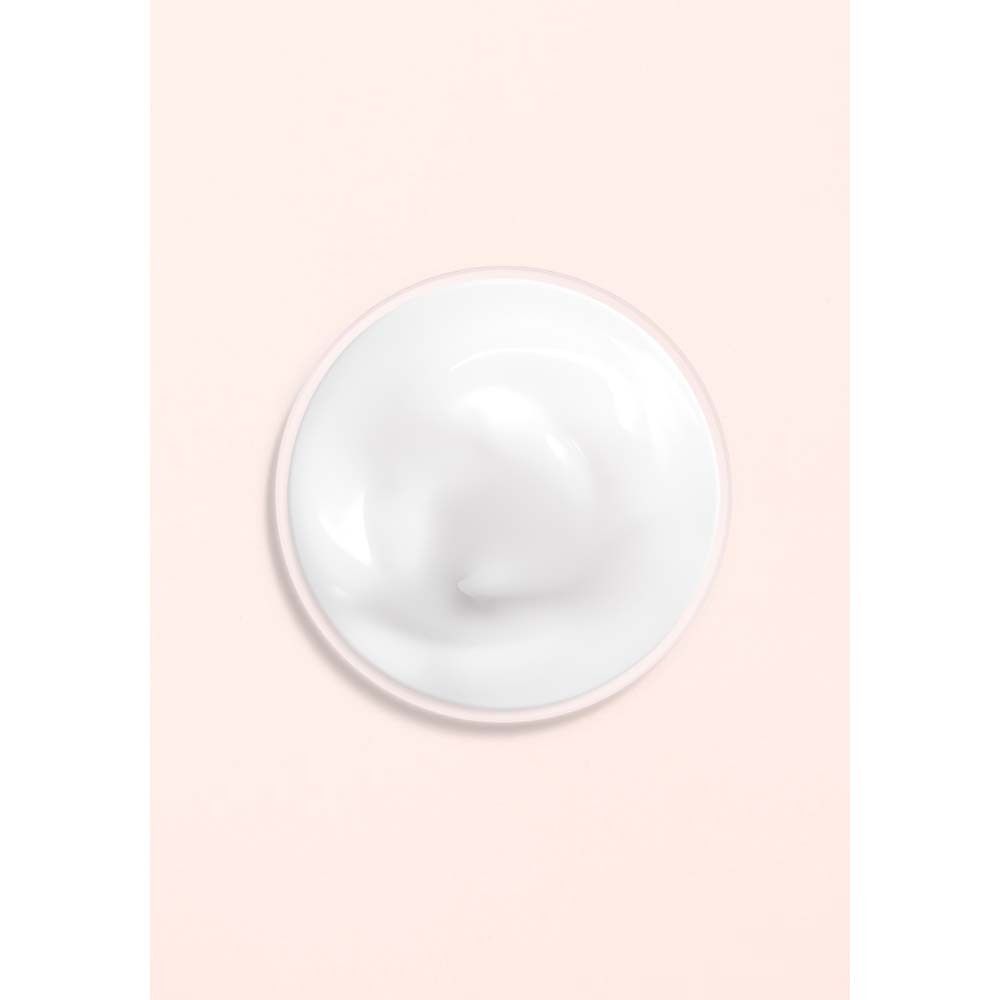 Weißes Creme-Produkt auf rosa Hintergrund. Runde Form.