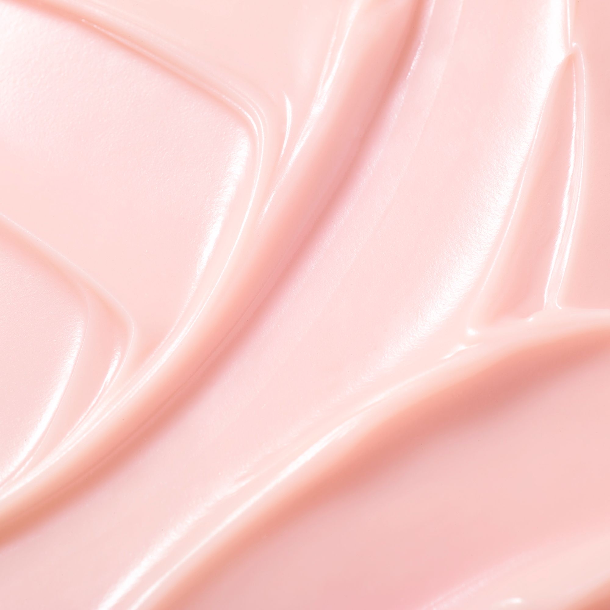 Nahaufnahme einer rosa Creme. Die Creme ist glatt und glänzend.