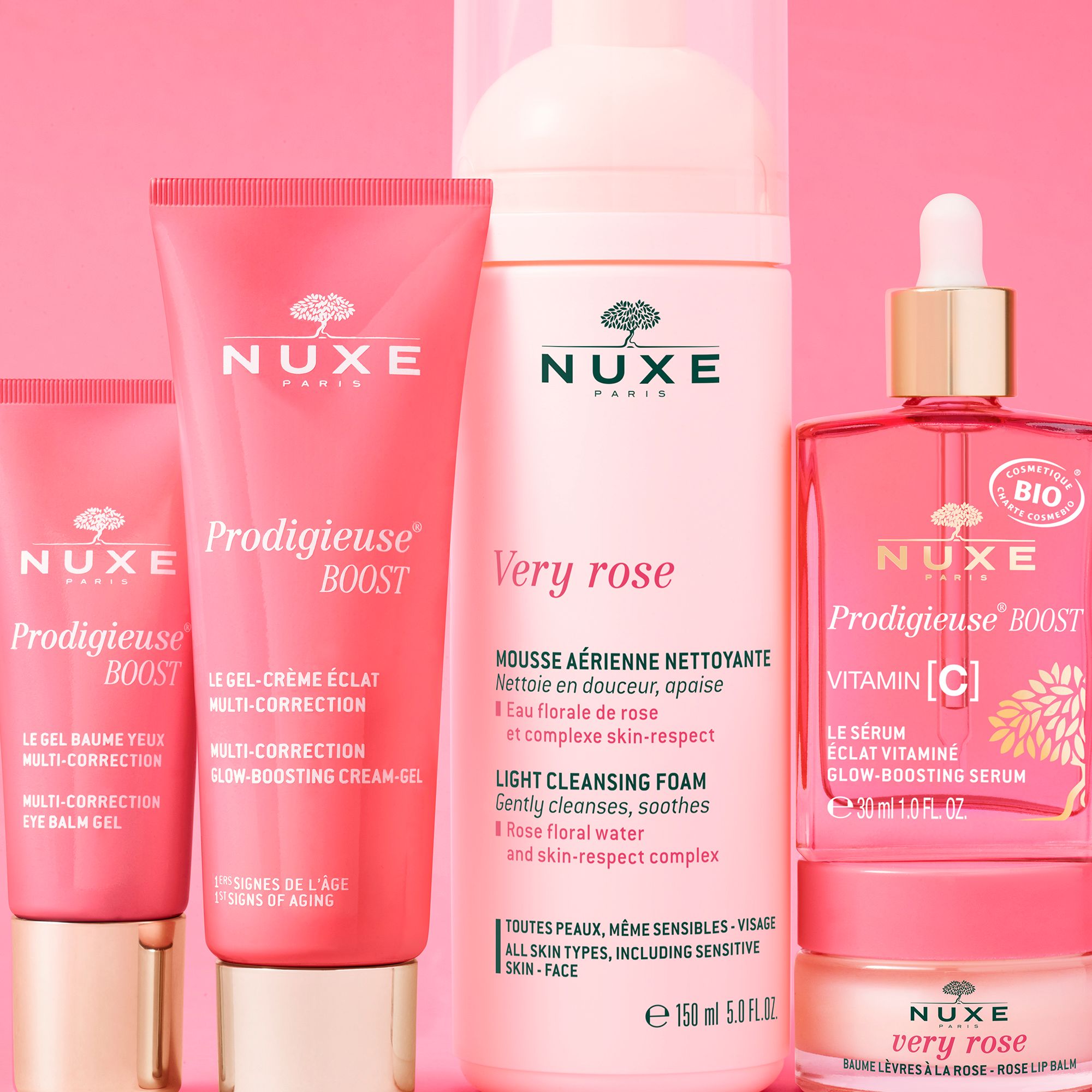 Verschiedene NUXE-Produkte. Enthalten: Prodigieuse Boost, Very Rose, Vitamin C Serum. Rosa und weiße Verpackungen.
