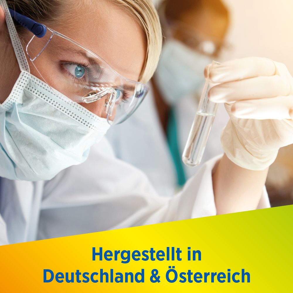 Wissenschaftlerin mit Reagenzglas. Aufschrift: Hergestellt in Deutschland & Österreich.